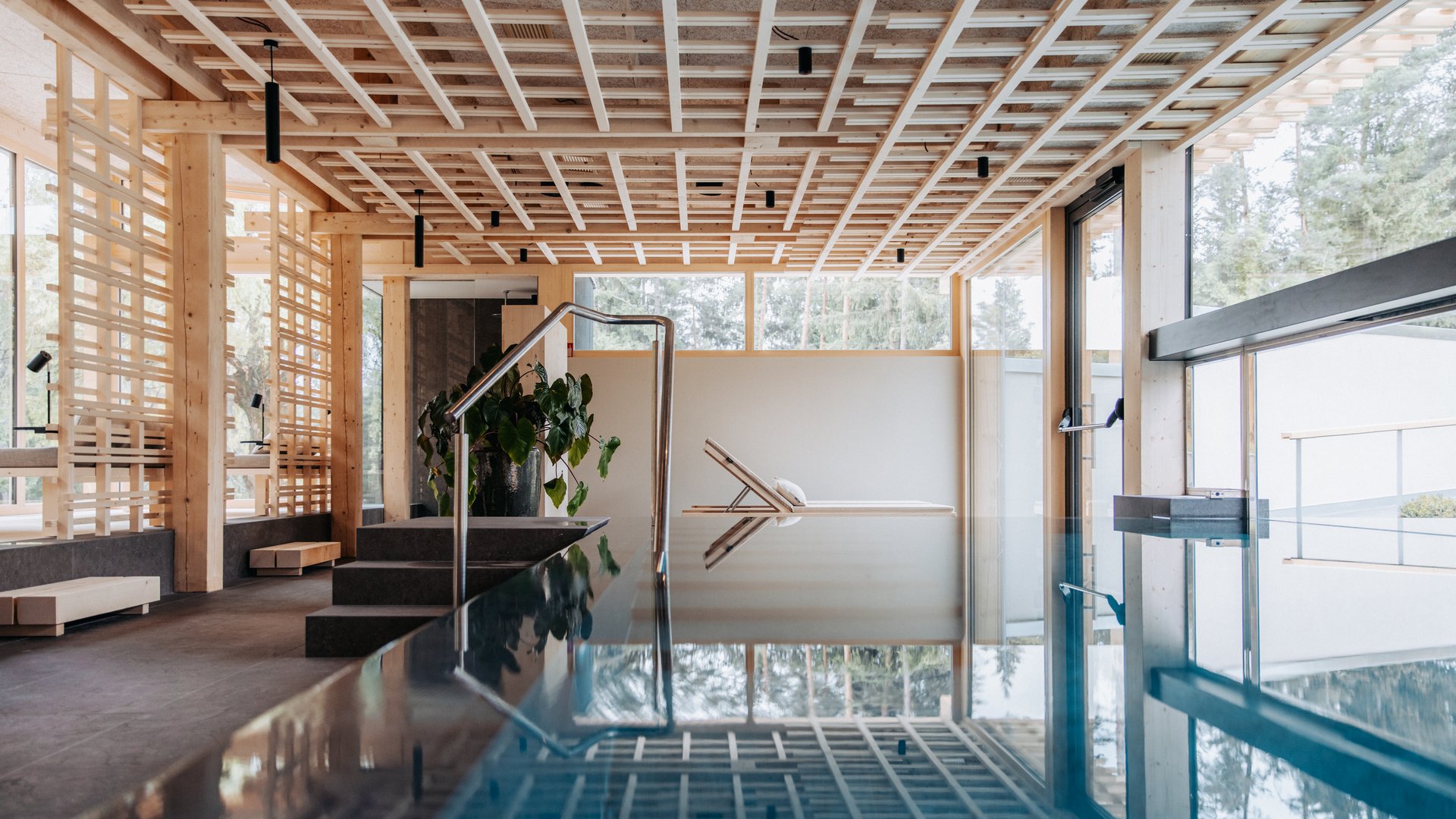 Wellness Aphrodite: Sensoria Dolomites unter den Siegern Moderner Innenpool mit Holzdecke und Liegestuhl am Fenster