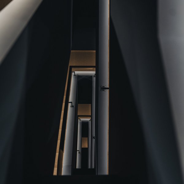 Your hotel in the Dolomites: Sensoria Dolomites View down a modern dark stairwell with multiple floors