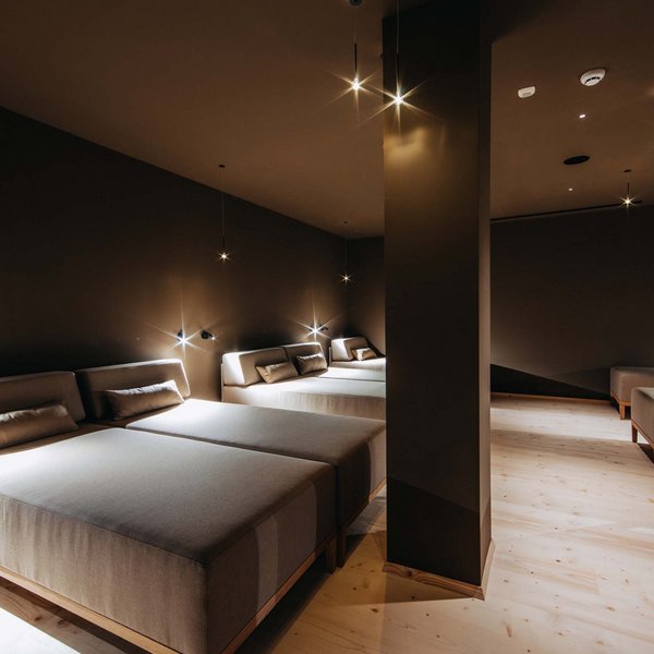 Your hotel in the Dolomites: Sensoria Dolomites Relax room with modern loungers and warm lighting