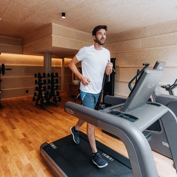 Your hotel in the Dolomites: Sensoria Dolomites Man running on treadmill in modern gym