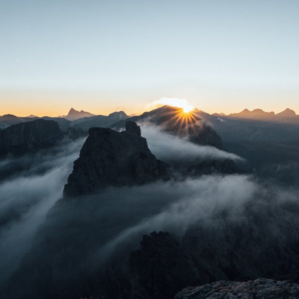 Your hotel in the Dolomites: Sensoria Dolomites Sunrise over misty mountains with clear sky