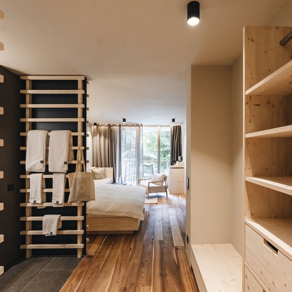 Your hotel in the Dolomites: Sensoria Dolomites Bright hotel room with wooden floor and modern minimalist design